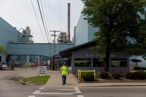 image of an industrial plant with a lone worker walking in